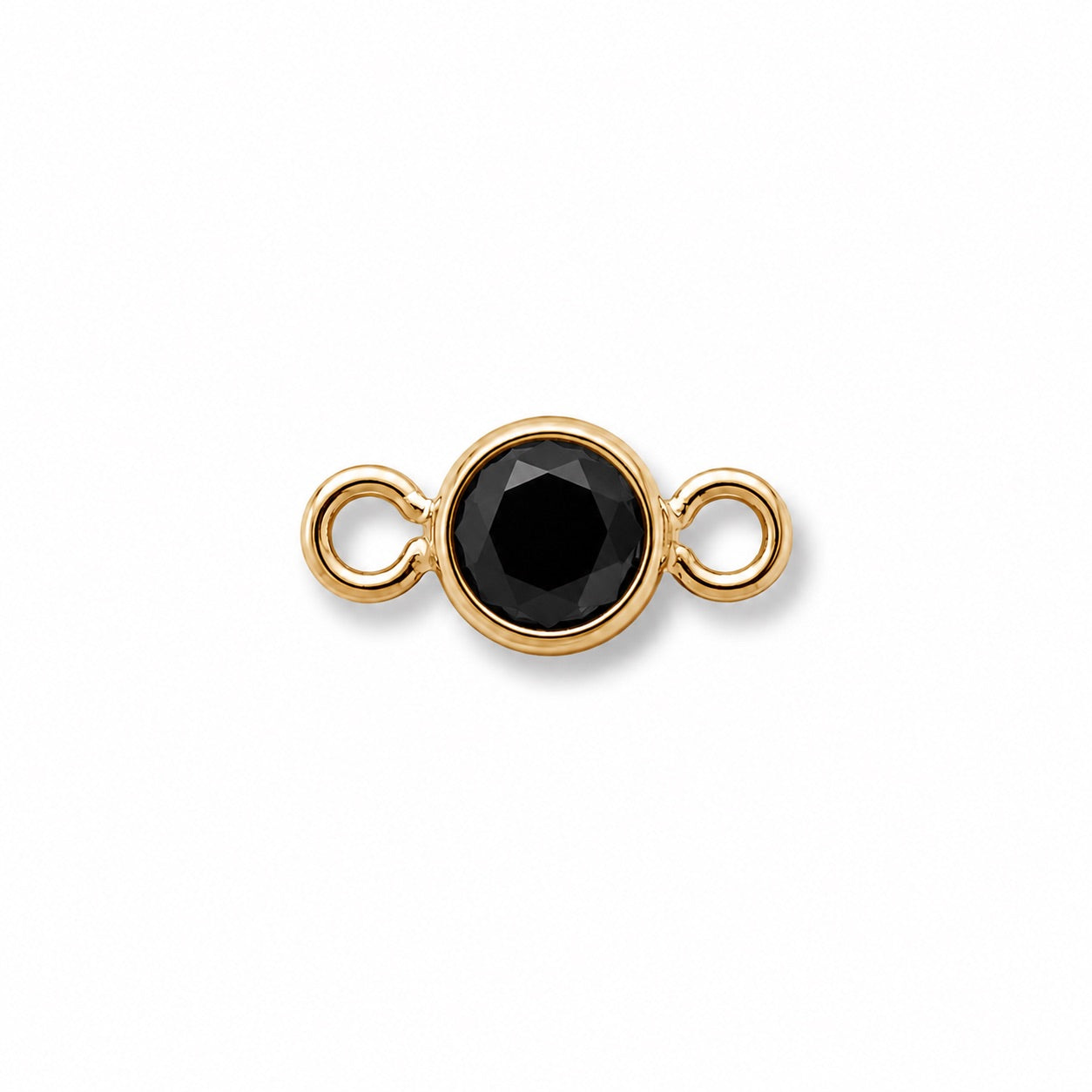 black faceted cut stone in gold bezel setting