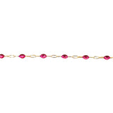 Gold chain with red gemstones on a white background