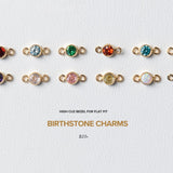 Collection of birthstone charms on a light gray background