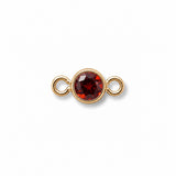 Gold jewelry connector with a January red garnet gemstone on a white background