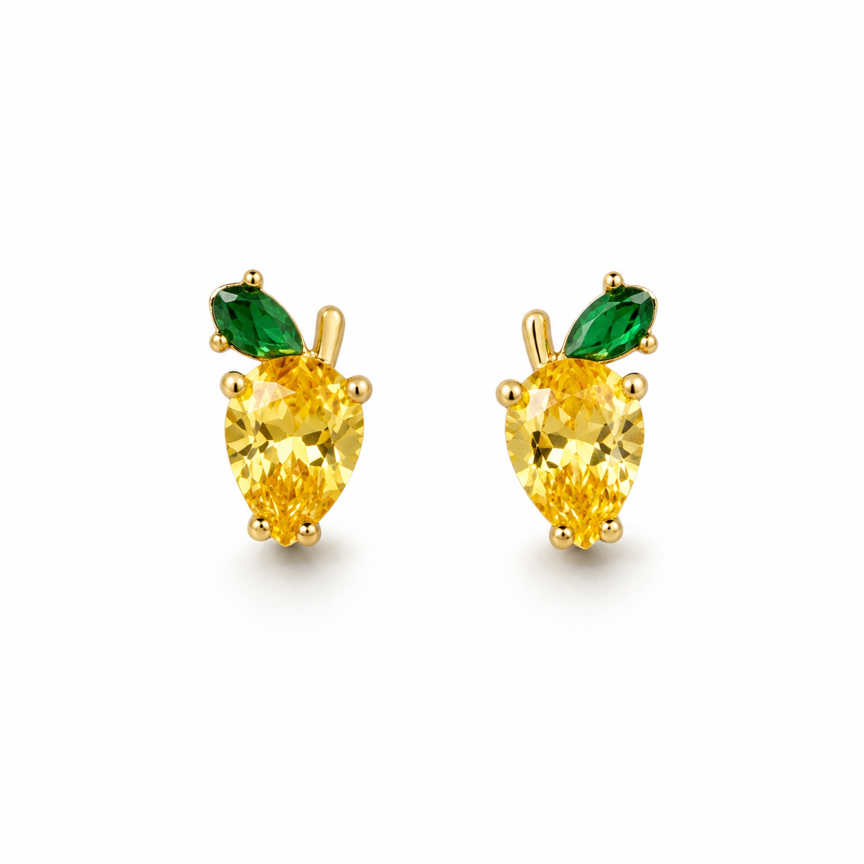 A pair of gold pear-cut stud earrings featuring a yellow center stone and a green marquise-shaped leaf above it, set against a plain white background.