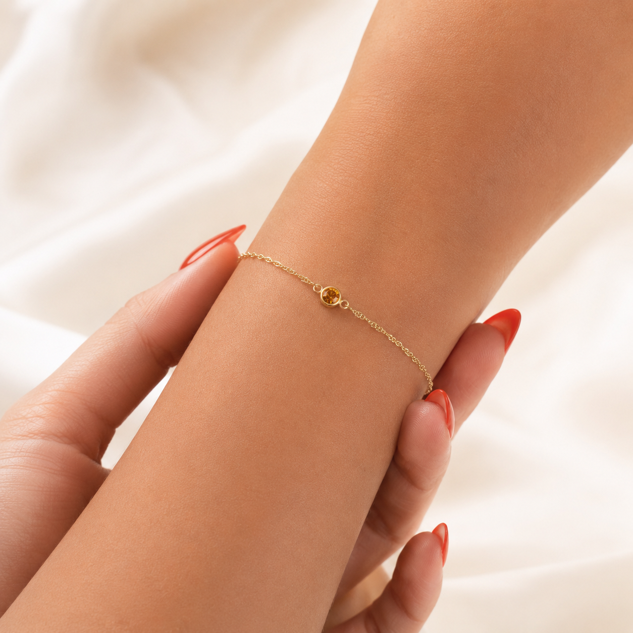 Gold bracelet on a person's wrist with a soft background