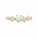 A gold-plated jewelry chain extender featuring a central round white opal surrounded by clear cubic zirconia stones on each side, set against a plain white background.