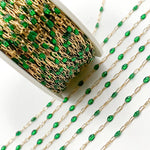 Gold chain with green beads on a white background
