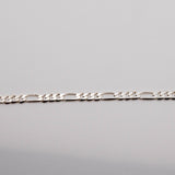 A silver-colored Hermes 925 bracelet laid out on a plain surface.