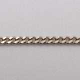 A silver curb-link chain bracelet with the brand name 'CASH' prominently displayed in the center.